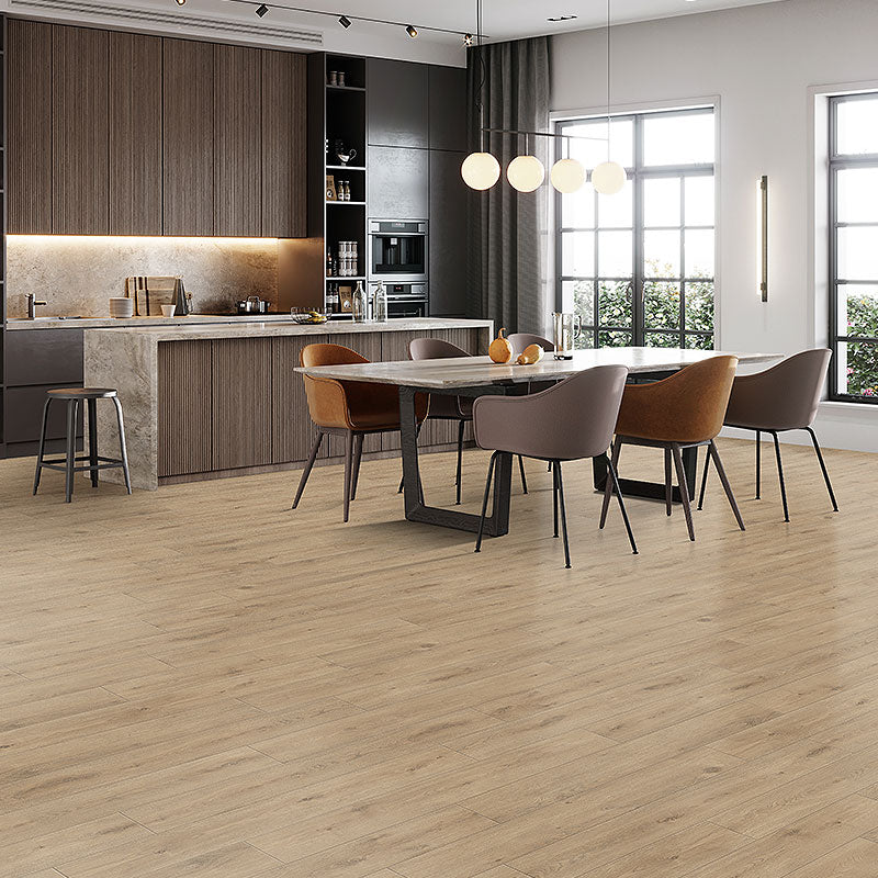 Natural toned oak grain laminate floor planks are water resistant enough they can be installed in a kitchen