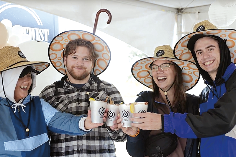 attendees in the VIP lounge at the annual Barley & Smoke charity event toasting their cups of Caesar cocktails