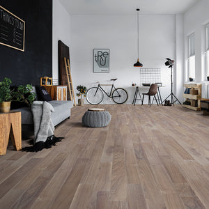 Modern living room with wooden flooring, furniture, and decor.