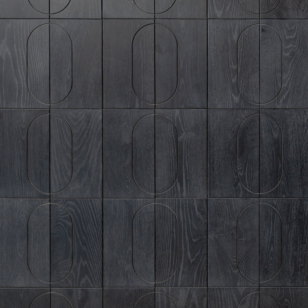 Dark gray wooden panel with circular cutouts