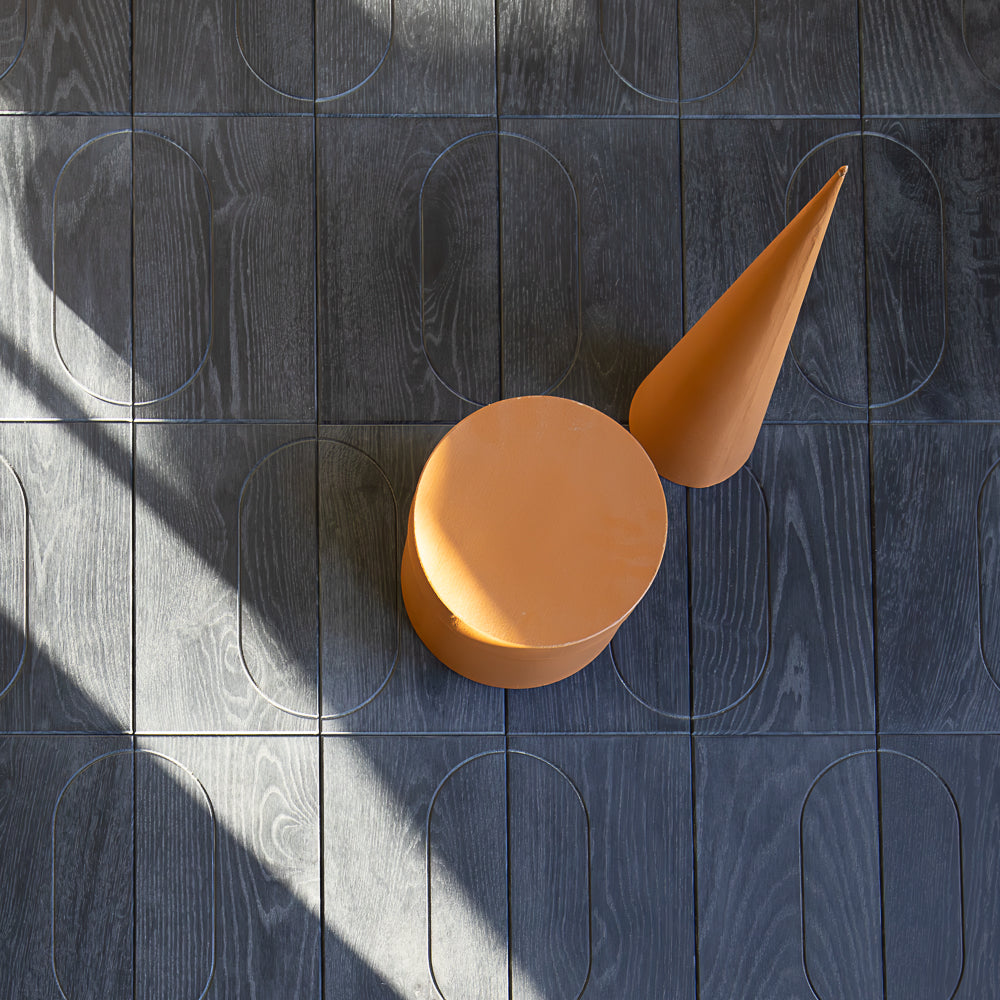Dark gray wooden panel with circular cutouts