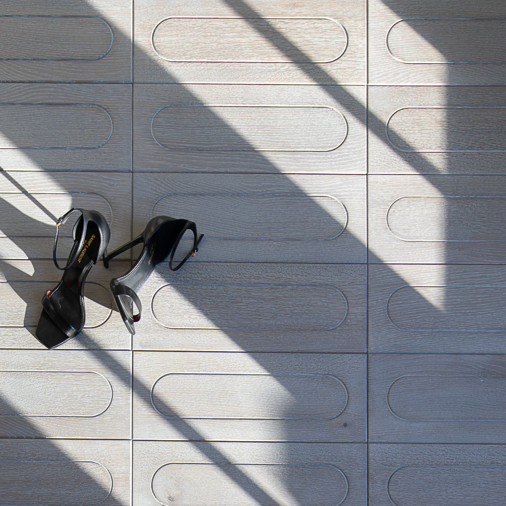 Patterned gray tiles with oval shapes on a textured surface