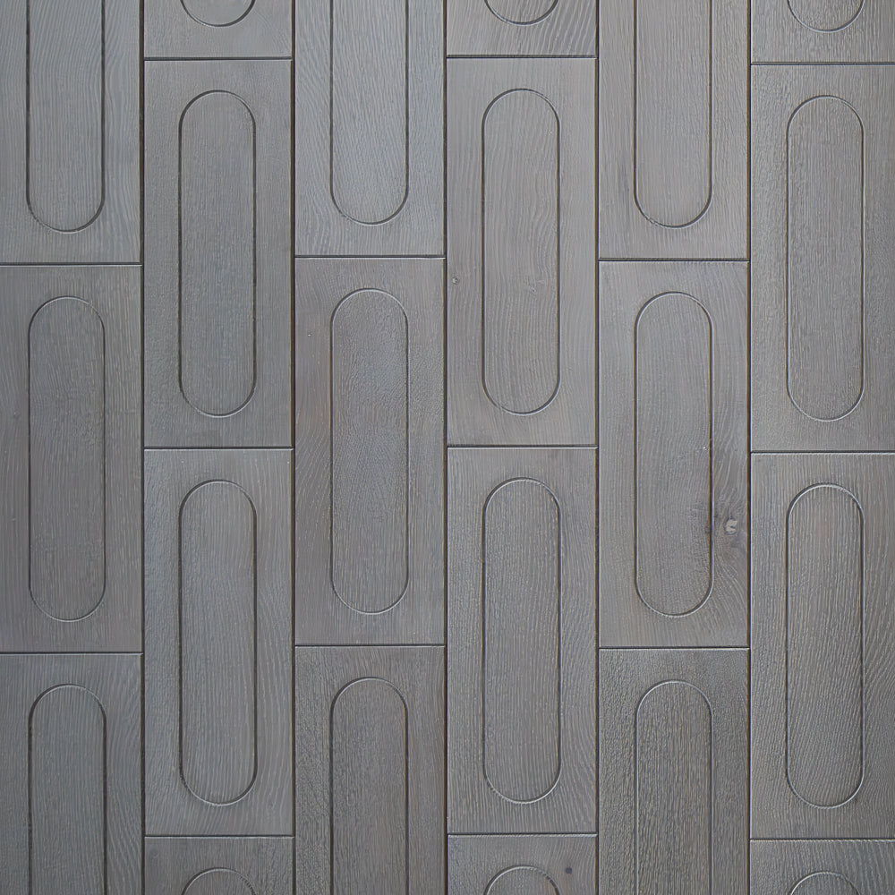 Patterned gray tiles with oval shapes on a textured surface