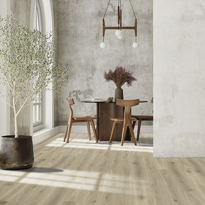 Laminate flooring installed in a dining room with concrete walls and boho chic furniture