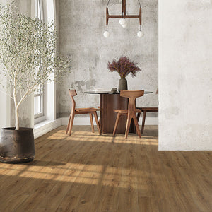 Warm toned laminate floor planks installed in a boho chic styled dining room