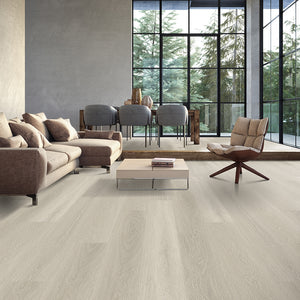 Light coloured vinyl plank flooring with oak grain in a contemporary living room with large floor to ceiling windows